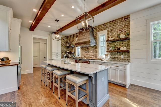 676 N Shore Dr, Cleveland, GA 30528 - kitchen featuring beam ceiling, light wood-style flooring, open shelves, white cabinets, and a kitchen bar