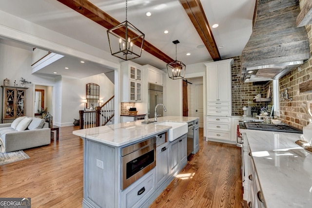 676 N Shore Dr, Cleveland, GA 30528 - kitchen featuring built in appliances, light wood finished floors, open floor plan, a sink, and light stone counters