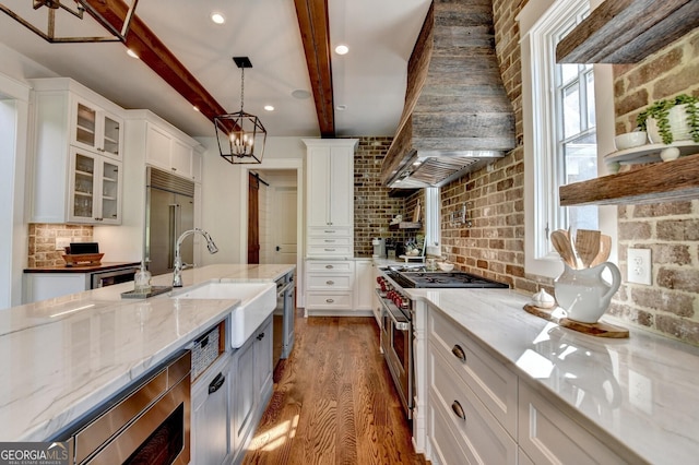 676 N Shore Dr, Cleveland, GA 30528 - kitchen featuring built in appliances, dark wood-style flooring, custom range hood, a sink, and white cabinetry