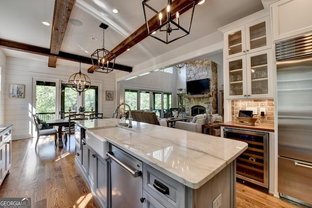 676 N Shore Dr, Cleveland, GA 30528 - kitchen featuring stainless steel appliances, wine cooler, wood finished floors, a sink, and a chandelier