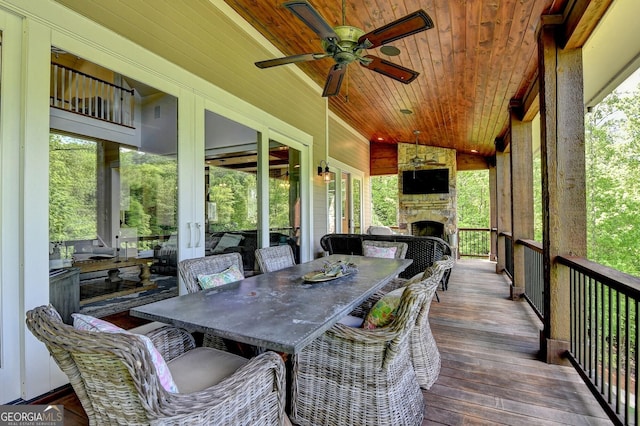676 N Shore Dr, Cleveland, GA 30528 - sunroom with an outdoor stone fireplace, ceiling fan, and healthy amount of natural light