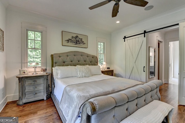 676 N Shore Dr, Cleveland, GA 30528 - bedroom featuring a barn door, wood finished floors, recessed lighting, baseboards, and crown molding