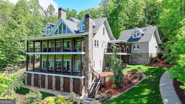 676 N Shore Dr, Cleveland, GA 30528 - back of house with a balcony, stone siding, a lawn, a chimney, and stairs