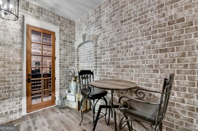 676 N Shore Dr, Cleveland, GA 30528 - dining room featuring wood finished floors and brick wall