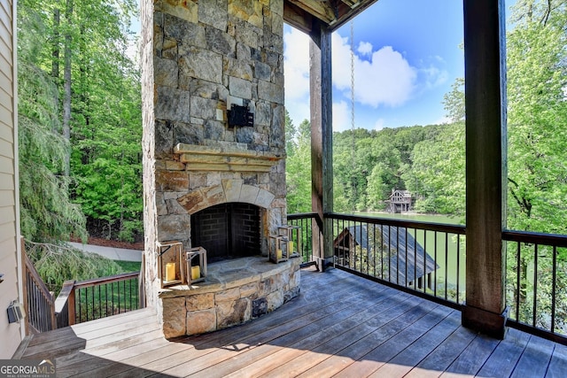 676 N Shore Dr, Cleveland, GA 30528 - wooden terrace with a fireplace and a wooded view