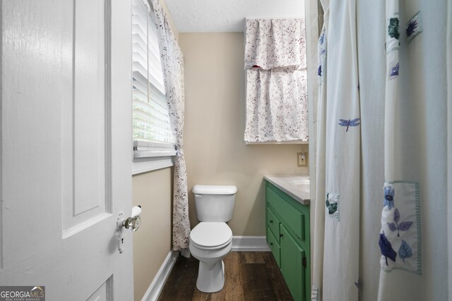 404 E 11th St SE, Rome, GA 30161 - bathroom with toilet, baseboards, wood finished floors, and vanity