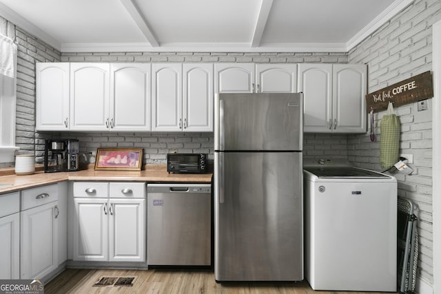 404 E 11th St SE, Rome, GA 30161 - kitchen featuring light countertops, washer / dryer, white cabinets, and stainless steel appliances