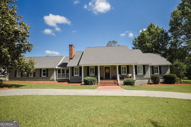 1737 Green Acres Dr, Vidalia, GA 30474 - ranch-style house with covered porch, a chimney, and a front lawn