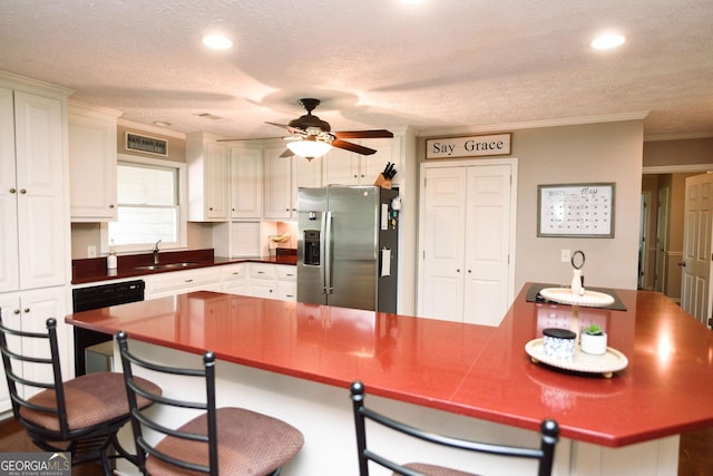 1737 Green Acres Dr, Vidalia, GA 30474 - kitchen featuring stainless steel fridge, a sink, a ceiling fan, a kitchen bar, and ornamental molding