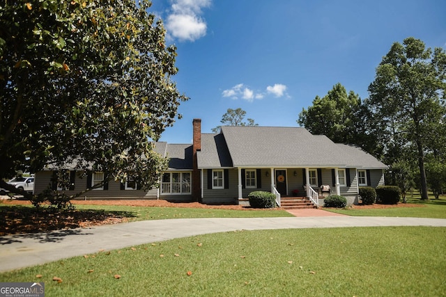 1737 Green Acres Dr, Vidalia, GA 30474 - view of front of home featuring covered porch, a chimney, and a front lawn