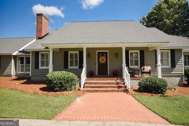 1737 Green Acres Dr, Vidalia, GA 30474 - view of front of property featuring a porch, a shingled roof, and a chimney