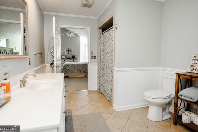1737 Green Acres Dr, Vidalia, GA 30474 - ensuite bathroom featuring visible vents, tile patterned flooring, wainscoting, toilet, and ensuite bathroom