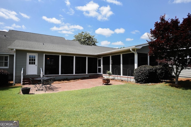 1737 Green Acres Dr, Vidalia, GA 30474 - rear view of property featuring a lawn, a patio, a shingled roof, and a sunroom