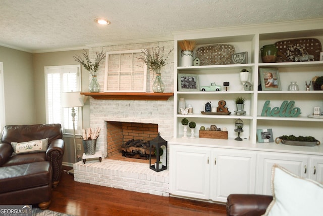 1737 Green Acres Dr, Vidalia, GA 30474 - interior space with crown molding, a textured ceiling, dark wood-style floors, and a brick fireplace