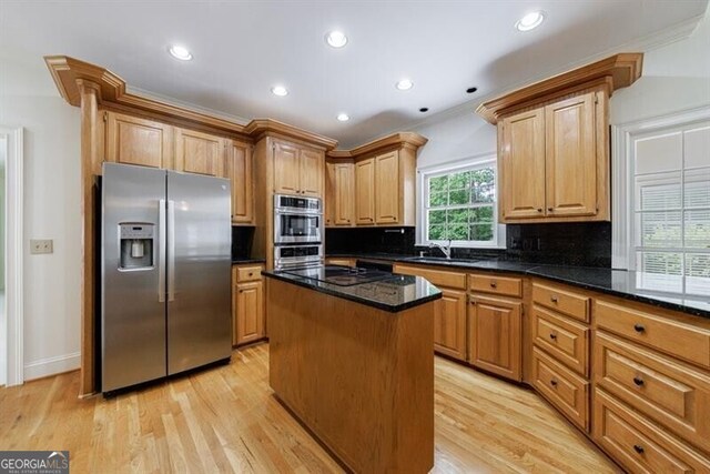 1730 Point Pleasant SE, Smyrna, GA 30080 - kitchen featuring decorative backsplash, light wood finished floors, a kitchen island, and stainless steel appliances