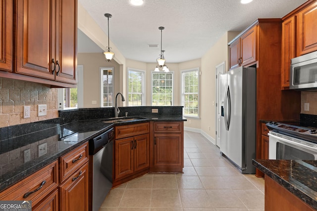 102 Herons Nest Cir, Kingsland, GA 31548 - kitchen with a sink, appliances with stainless steel finishes, tasteful backsplash, and brown cabinetry