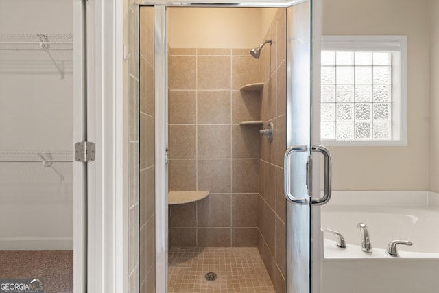 102 Herons Nest Cir, Kingsland, GA 31548 - bathroom with a walk in closet, a garden tub, and a stall shower