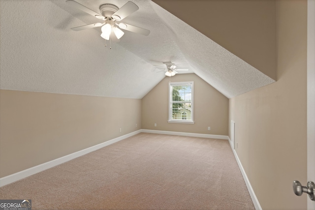 102 Herons Nest Cir, Kingsland, GA 31548 - additional living space featuring ceiling fan, carpet floors, a textured ceiling, baseboards, and vaulted ceiling