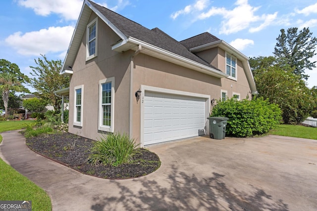 102 Herons Nest Cir, Kingsland, GA 31548 - view of home's exterior with a garage, driveway, and stucco siding