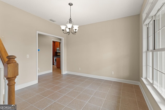 102 Herons Nest Cir, Kingsland, GA 31548 - spare room with an inviting chandelier, visible vents, baseboards, stairway, and light tile patterned floors