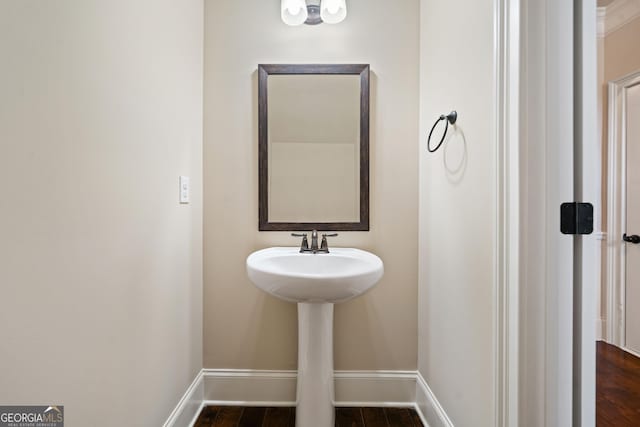1314 Bentley Estates Dr, Dacula, GA 30019 - bathroom featuring baseboards, wood finished floors, and a sink