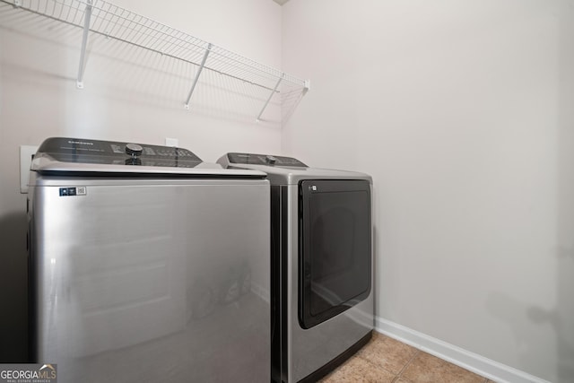 1314 Bentley Estates Dr, Dacula, GA 30019 - washroom featuring baseboards, washer and dryer, and light tile patterned floors
