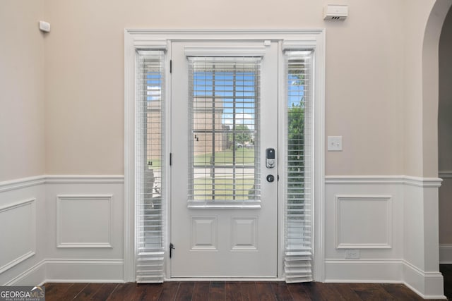 1314 Bentley Estates Dr, Dacula, GA 30019 - foyer entrance featuring arched walkways, a wainscoted wall, healthy amount of natural light, dark wood-style flooring, and a decorative wall