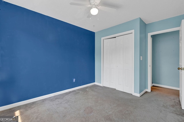 7293 Bridlewood Ct, Jonesboro, GA 30236 - unfurnished bedroom with a closet, baseboards, a ceiling fan, and carpet flooring