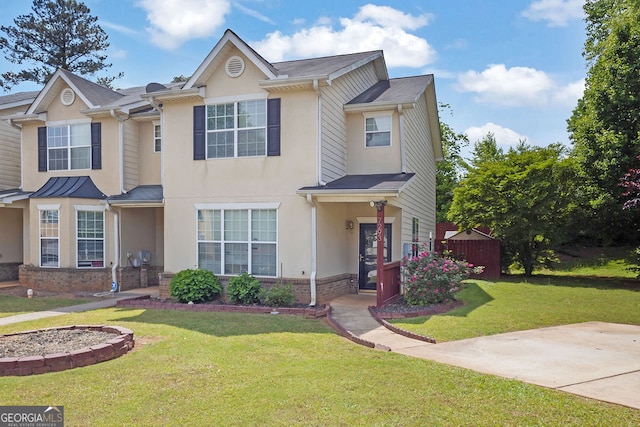 7293 Bridlewood Ct, Jonesboro, GA 30236 - view of front facade with brick siding, a front yard, and stucco siding