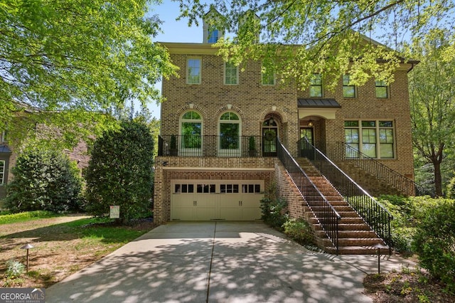 611 Timm Valley Rd NE Unit 2, Atlanta, GA 30305 - view of front of house featuring brick siding, an attached garage, stairway, and concrete driveway