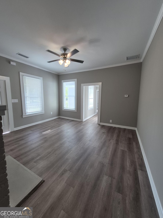 127 S Church St, Bogart, GA 30622 - unfurnished living room with crown molding, visible vents, baseboards, and dark wood-type flooring