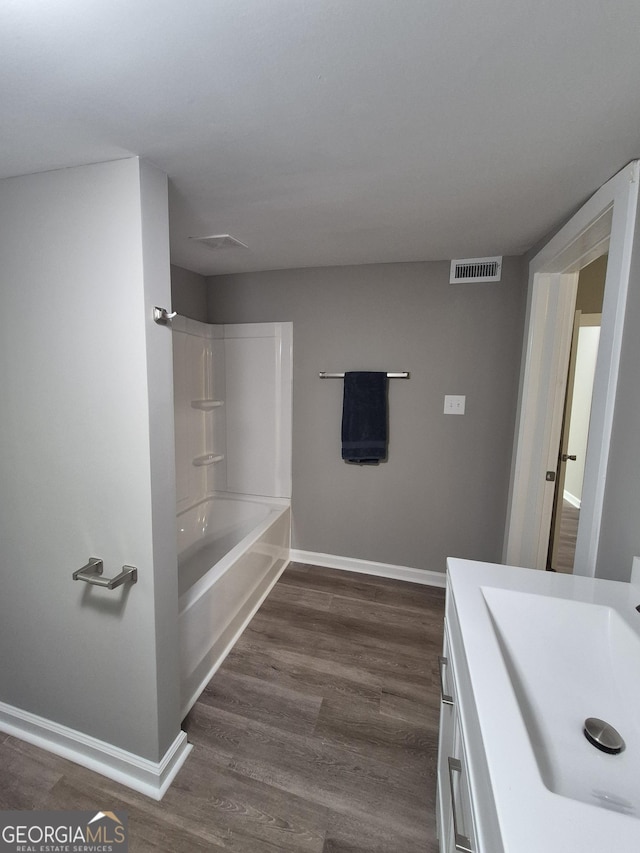 127 S Church St, Bogart, GA 30622 - bathroom featuring wood finished floors, vanity, visible vents, baseboards, and bathtub / shower combination