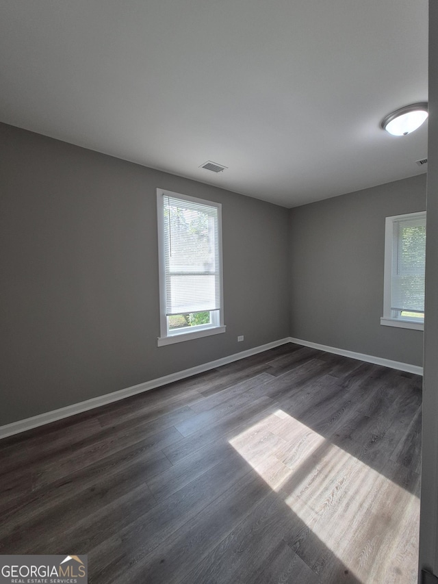 127 S Church St, Bogart, GA 30622 - empty room with visible vents, baseboards, and dark wood-type flooring