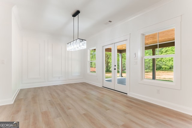4731 H D Atha Rd, Covington, GA 30014 - unfurnished dining area featuring light wood-type flooring, french doors, and a chandelier