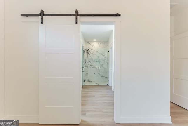 4731 H D Atha Rd, Covington, GA 30014 - hallway with light wood-type flooring and a barn door