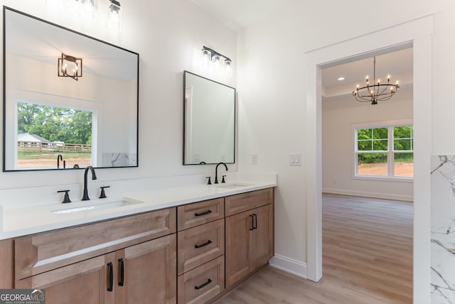 4731 H D Atha Rd, Covington, GA 30014 - full bath featuring double vanity, a chandelier, and wood finished floors