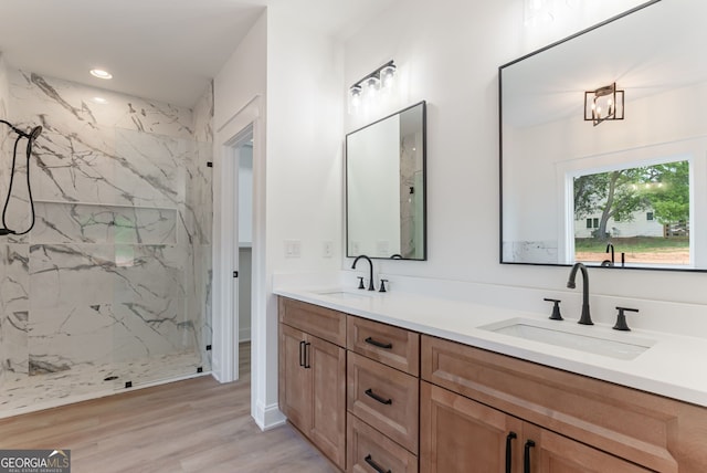 4731 H D Atha Rd, Covington, GA 30014 - bathroom with double vanity, a marble finish shower, and wood finished floors
