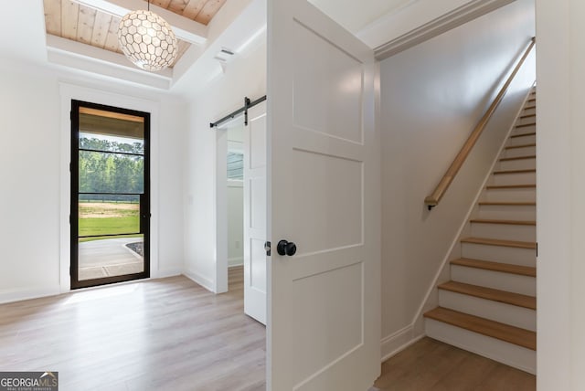 4731 H D Atha Rd, Covington, GA 30014 - foyer featuring a barn door, light wood finished floors, stairway, and wooden ceiling