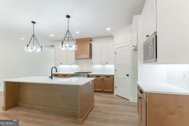 4731 H D Atha Rd, Covington, GA 30014 - kitchen with custom exhaust hood, light wood-style floors, tasteful backsplash, pendant lighting, and white cabinetry