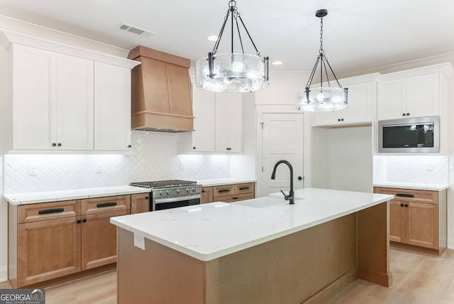 4731 H D Atha Rd, Covington, GA 30014 - kitchen with stainless steel appliances, premium range hood, decorative backsplash, light wood-style floors, and light stone countertops