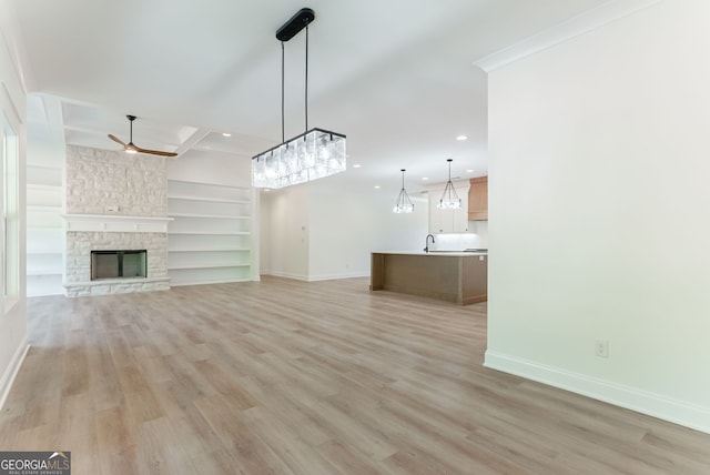 4731 H D Atha Rd, Covington, GA 30014 - unfurnished living room featuring light wood finished floors, ceiling fan, recessed lighting, built in features, and a fireplace