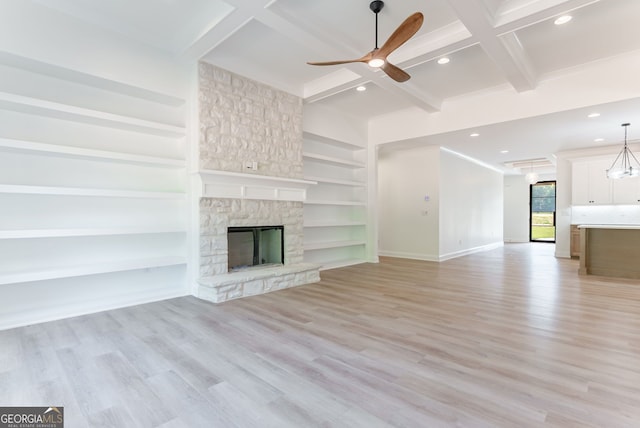 4731 H D Atha Rd, Covington, GA 30014 - unfurnished living room with ceiling fan, recessed lighting, light wood finished floors, a stone fireplace, and beamed ceiling