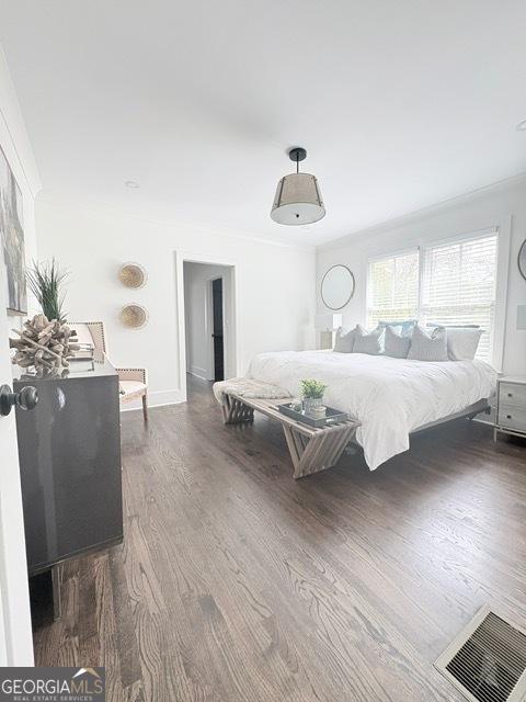 bedroom featuring dark wood-style flooring and baseboards
