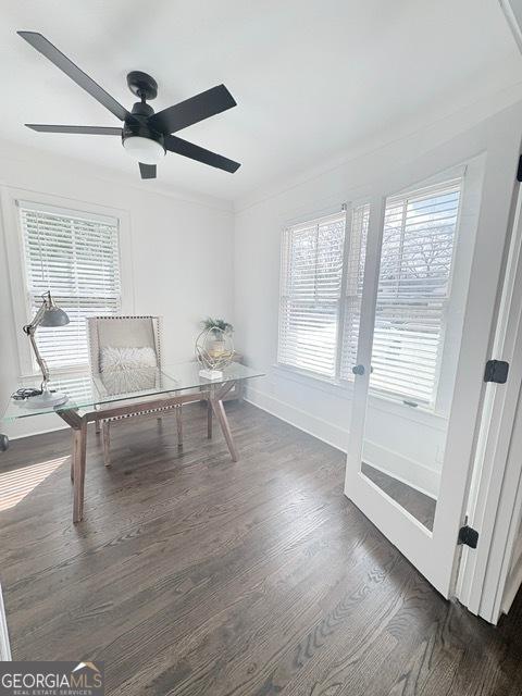 office area featuring plenty of natural light, dark wood-style floors, and a ceiling fan
