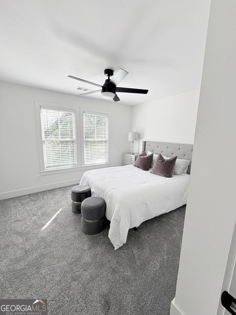 carpeted bedroom featuring baseboards and a ceiling fan