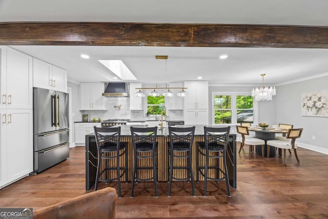 125 Terrell Dr, Athens, GA 30606 - kitchen with high end refrigerator, wall chimney exhaust hood, a chandelier, dark wood-type flooring, and white cabinets
