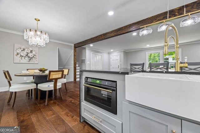 kitchen with crown molding, oven, dark wood-style flooring, recessed lighting, and pendant lighting