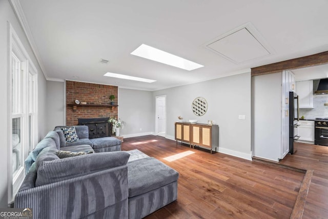 living room with visible vents, ornamental molding, a fireplace, baseboards, and dark wood-style floors