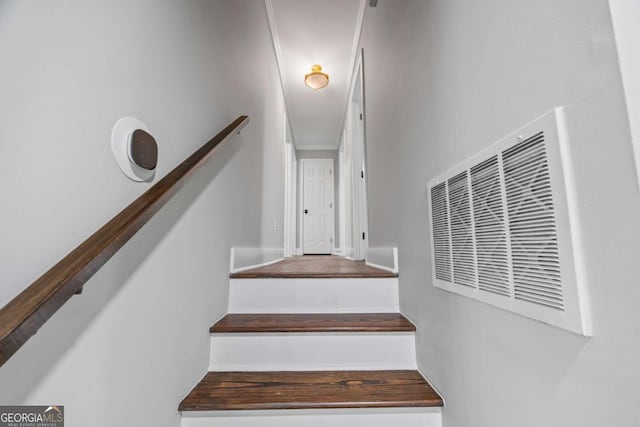 stairs with visible vents and a heating unit