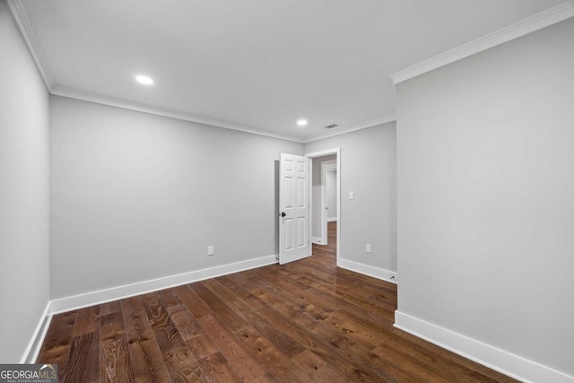 empty room with dark wood-type flooring, ornamental molding, baseboards, and recessed lighting